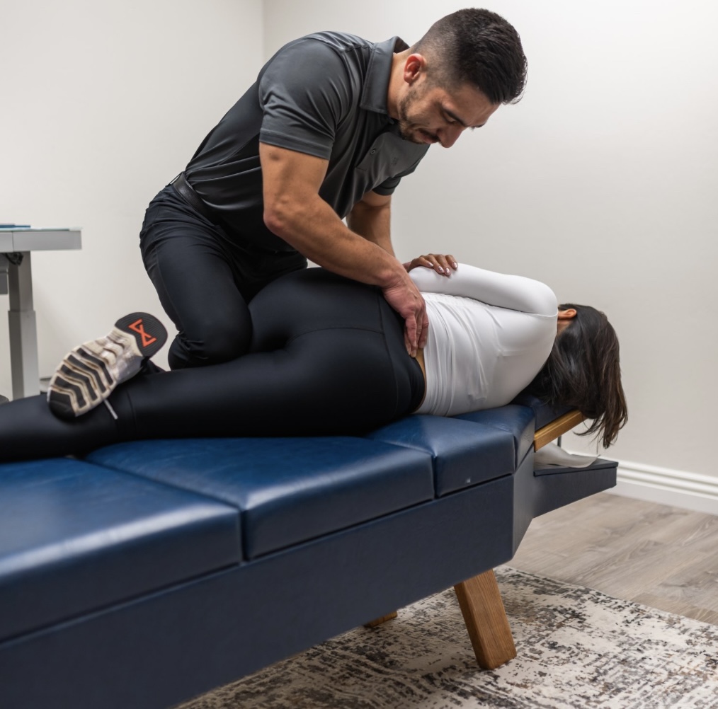 Dr. Mike performing a lumbar adjustment on a patient